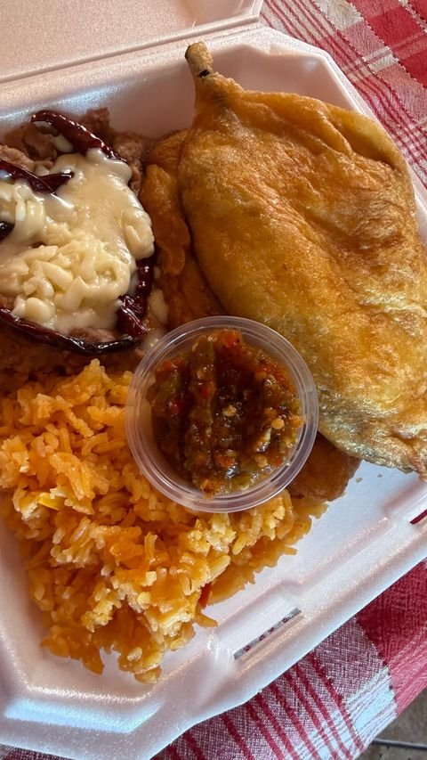 Chile relleno plate with rice and salsa from Nelly's Kitchen & Catering