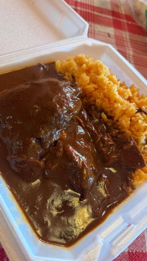Homemade mole with Mexican rice prepared by Nelly's Kitchen